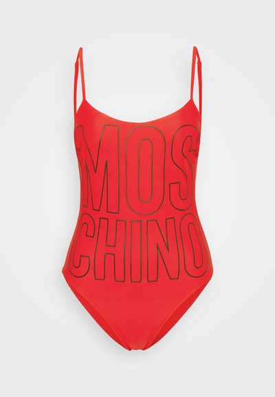 Red swimsuit with thin straps, featuring a large black "MOSCHINO" logo on the front. Smooth texture and fitted design.