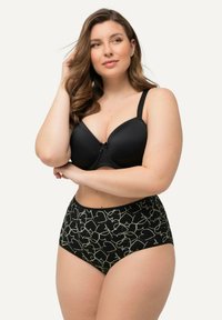 Czarna, wyściełana bielizna z koronkowym wykończeniem i kokardką, w zestawie z czarnymi majtkami o wysokim stanie z zielonym abstrakcyjnym wzorem serca.