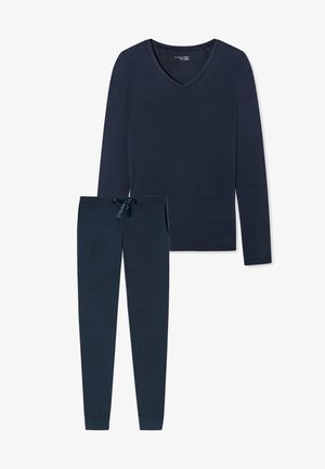 Tummansininen pitkähihainen V-pääntie paita ja siihen sopivat slim-fit housut naruoluella. Pehmeä kangas, minimaalinen rakenne ja ei näkyviä kuvioita.