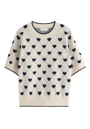 Krémový svetr s kulatým výstřihem a námořnickým vzorem srdíček. Krátké rukávy, žebrovaný límec a spodní lem, měkká pletená struktura. Po celé ploše puntíkované akcenty.