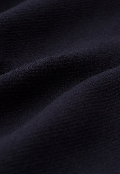 Navy textured fabric with a soft, smooth surface and subtle ribbed pattern, indicating warmth and versatility in use.
