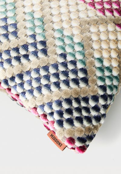 Colorful, textured cushion featuring plush, polka-dot pattern in shades of teal, navy, and pink with a Missoni logo tag.