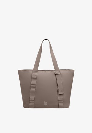 Sac fourre-tout taupe avec longues poignées et sangle ajustable, forme rectangulaire, design minimaliste, et petit logo "GOT BAG" au centre en bas.