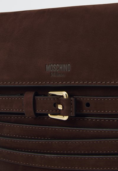 Rudas suedinis Moschino Milano krepšys su auksiniu sagtimi ir horizontaliai siuvinėtomis diržo detalėmis.