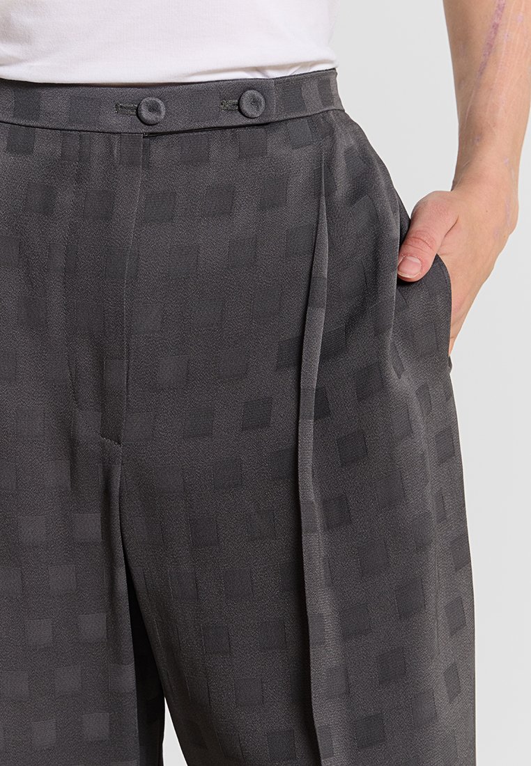 Grau gemusterte Hose aus leichtem Stoff, mit zwei Knöpfen an der Taille, vorderen Falten und seitlichen Taschen.