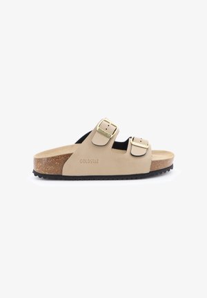 Sandalo beige con suola in sughero, due fibbie regolabili dorate e marchio "Goldstar" sul lato, mostrato di profilo su sfondo bianco.