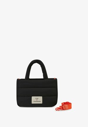 Black rectangular padded handbag with two handles and a detachable bright orange strap beside it, front metal logo plate visible.