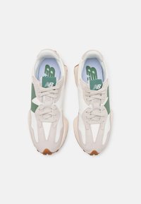 Sport shoes in white, green, and beige. Features a mix of leather and suede. Rounded toe, flat sole, and lace-up design.