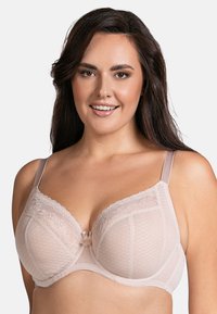 Bra in rosa chiaro con coppe morbide e bordo in pizzo. Presenta un delicato motivo floreale, spalline regolabili e un accento centrale a forma di fiocco.