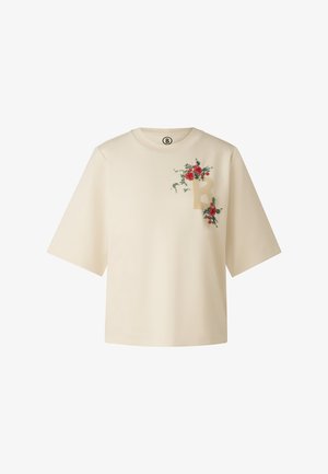Light beige t-shirt with short sleeves, featuring floral embroidery in red and green, and a prominent letter "B" design on the front.