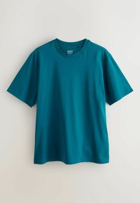 Tirkīza īsām piedurknēm T-krekls, izgatavots no kokvilnas, ar apaļu kakla izgriezumu un regulāru piegriezumu. Gluda tekstūra bez redzamām rakstainām vai rotājumiem.