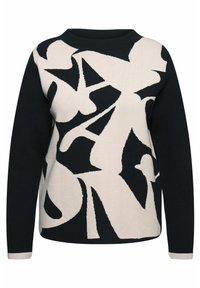 Jersey de punto con base negra y grandes patrones abstractos en blanco. Cuello redondo y mangas largas con puños en contraste.