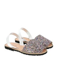 Glittery sandals with a wide, sparkly upper in multicolor and silver straps. Flat black sole, open-toe design, and elastic back straps.