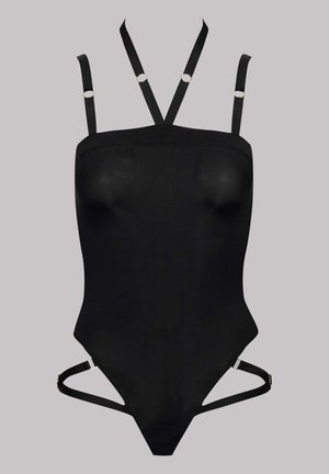 Bodysuit noir au design près du corps. Doté de bretelles ajustables avec des anneaux dorés et de découpes sur les côtés. Matériau lisse et extensible.