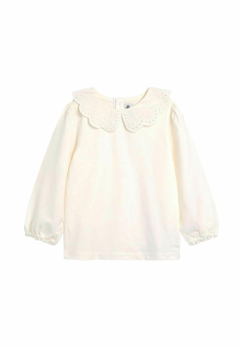 Cremfarbene Bluse mit langen Ärmeln, einem gewellten Lochmusterkragen, elastischen Bündchen und einem Knopfverschluss im Rücken. Aus weichem Baumwollstoff.