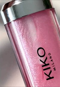 Rosa kosmetikflaska med skimrande yta, silverlock och svart "KIKO MILANO"-logotyp. Den genomskinliga designen visar produkten inuti.