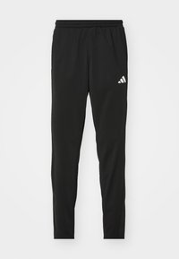 Svarta träningsbyxor med elastiskt midjeband, smalnande design och en vit Adidas-logotyp på vänster lår. Slätt, lätt tyg.