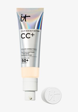 Tube de crème CC+ Your Skin But Better de IT Cosmetics avec SPF 50+, correcteur de couleur, anti-âge, sérum hydratant, avec bouchon enlevé et placé à côté.