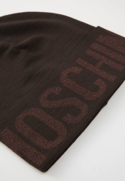 Berretto di maglia marrone con una fascia testurizzata marrone scuro che presenta un logo leggermente lucido di un contrastante color bordeaux. Materiale morbido e leggero.