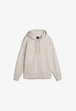 Beige Reißverschluss-Hoodie mit Fronttaschen, Kordelzugkapuze, gerippten Bündchen und dezentem, auf der Brust gesticktem Logo.