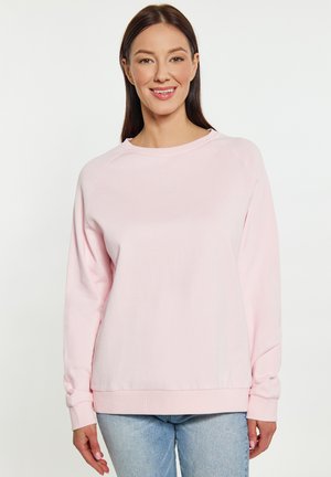 Lichtroze sweatshirt met ronde hals, geribde manchetten en een ontspannen pasvorm. Gemaakt van een zachte stof, met raglanmouwen en minimale naden.
