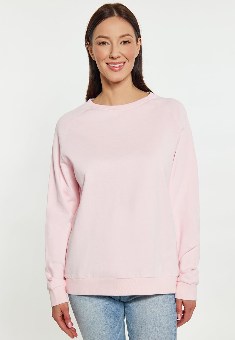 Lichtroze sweatshirt met ronde hals, geribde manchetten en een ontspannen pasvorm. Gemaakt van een zachte stof, met raglanmouwen en minimale naden.