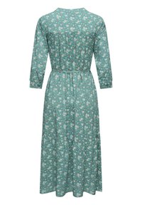 Floral dress in teal fabric with three-quarter sleeves, belted waist, and tiered skirt. Features white and orange flower patterns throughout.