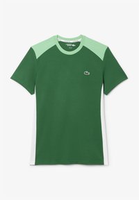 Tricou verde cu mâneci raglan de un verde deschis, guler rotund și un mic logo pe pieptul stâng. Fabricat dintr-un material moale și ușor.