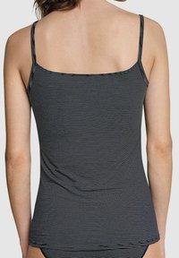 Black and white striped tank top with thin straps, a square neckline, and a relaxed fit that drapes slightly over the waist.