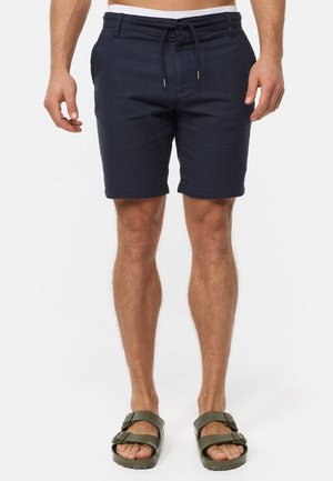 Shorts bleu marine en tissu léger, avec une taille à cordon de serrage, des poches latérales et une coupe décontractée se terminant au-dessus du genou.
