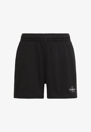 Pantaloni scurți negri cu talie elastică și logo Calvin Klein pe partea inferioară dreaptă a piciorului, afișați pe fundal alb.