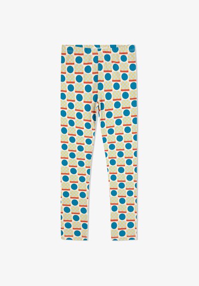 Mønstret leggings med en cremefarvet baggrund med blå cirkler og orange-stribede firkanter i et gentaget design. Fremstillet af elastisk materiale.
