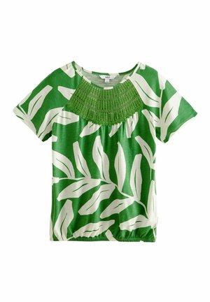 Groen kortemouwen blouse met grote witte bladpatronen en gedetailleerd groen geborduurd juk, elastische zoom en ronde halslijn.