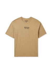 Beżowy oversize t-shirt z bawełny, z krótkimi rękawami i okrągłym dekoltem. Na piersi czarny napis "California Never Stops".