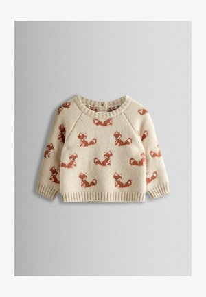 Smėlio spalvos megztinis su kartojančiu voverės raštu rūdžių spalva. Megztas ribotas kaklas ir rankogaliai, su trijų ketvirčių ilgio rankovėmis.