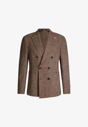 Brązowy żakiet w kratekę houndstooth z podwójnym zapięciem, z wykończeniem w szpic, dwoma przednimi kieszeniami i teksturowanym wykończeniem. Posiada czarne guziki i akcent w postaci kwiatu.