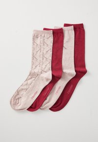 Four folded Calvin Klein socks in alternating light pink and dark red, two patterned with CK logo and two solid colored, arranged side by side.