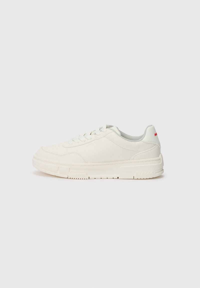 White sneakers with a smooth leather upper, round toe, flat laces, and a textured rubber sole. A red accent is on the heel.