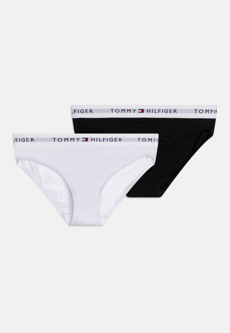 Lot de deux culottes en coton, une blanche et une noire, présentant une ceinture élastique logo avec des accents rouges et bleus.