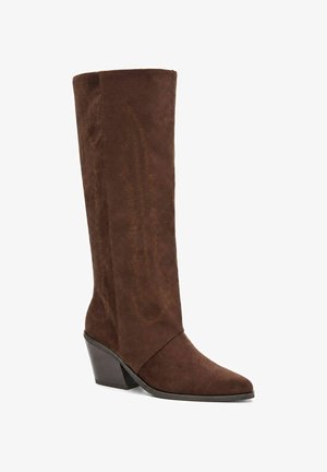 Stivale da cowboy in camoscio marrone con tacco in legno inclinato di altezza media e cuciture decorative sul gambale.