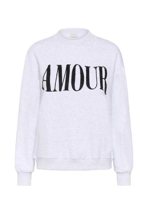 Sweat-shirt blanc à manches longues avec poignets et ourlet côtelés, présentant de grandes lettres noires perlées formant le mot "AMOUR" sur la poitrine.