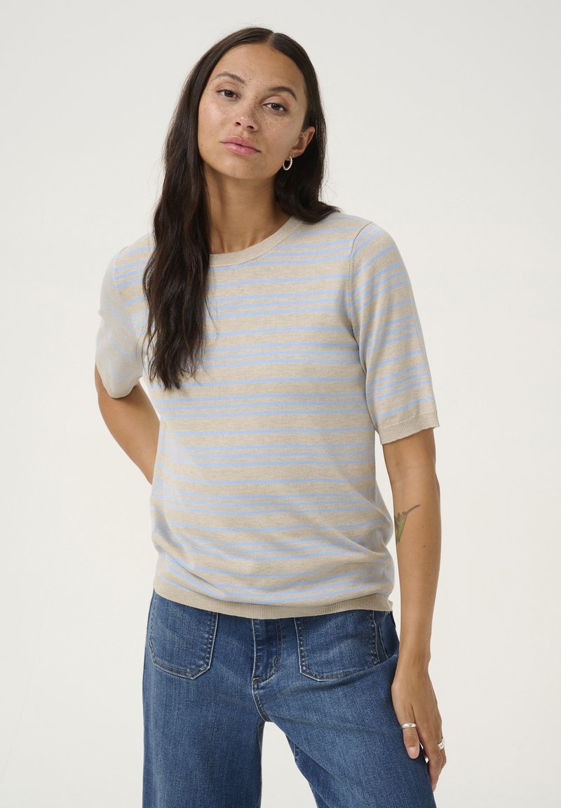 Light beige short-sleeve sweater with horizontal blue stripes. Soft texture, round neckline, and slightly loose fit. Paired with blue jeans.