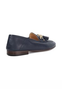 Navy leather loafer with a flat heel, featuring a decorative tassel and gold-tone hardware accents. Smooth texture and rounded toe design.