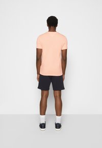 Tommy Hilfiger TOMMY LOGO TEE - T-shirt estampada - sunset peach