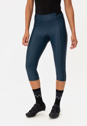Navy blauwe fiets capri's gemaakt van rekbaar materiaal, met een gevoerd zitgedeelte, gebogen naden en een lengte tot halverwege het kuit.