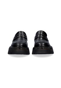 Mocasines de cuero negro con banda de tachuelas en la parte superior, lados texturizados y suela de goma gruesa. La vista frontal resalta el acabado suave y los materiales contrastantes.