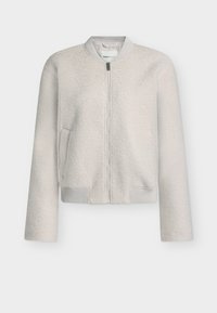 Lyse grå, teksturert bomberjakke med glidelås foran, ribbestrikkede mansjetter og rund halslinning. Har sidelommer og et mykt, koselig utseende.