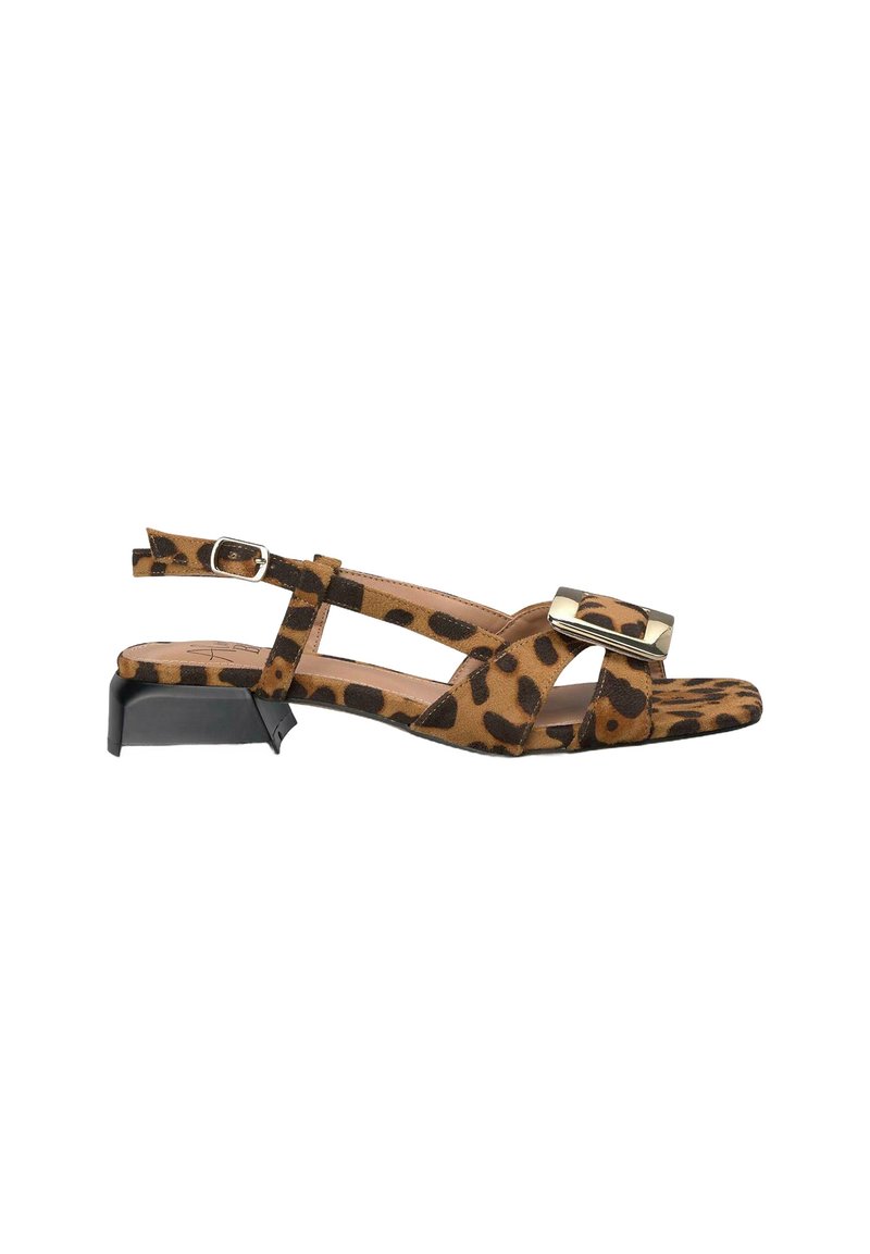 Leopard print suede sandal with a low block heel, crisscross straps, metallic buckle accent, and open toe design.