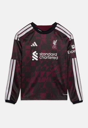 Maillot de football Liverpool FC à manches longues, à carreaux bordeaux et noirs, avec des bandes blanches Adidas et des logos de sponsors sur le devant et les manches.