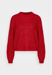 Maglione spesso rosso a maglia con maniche lunghe, polsini a costina e un colletto rotondo a costina su uno sfondo chiaro e semplice.